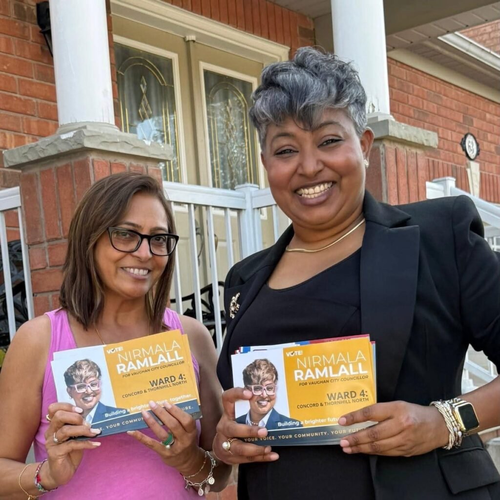 Nirmala Ramlall and a Ward 4 resident on her front porch, both holding campaign flyers