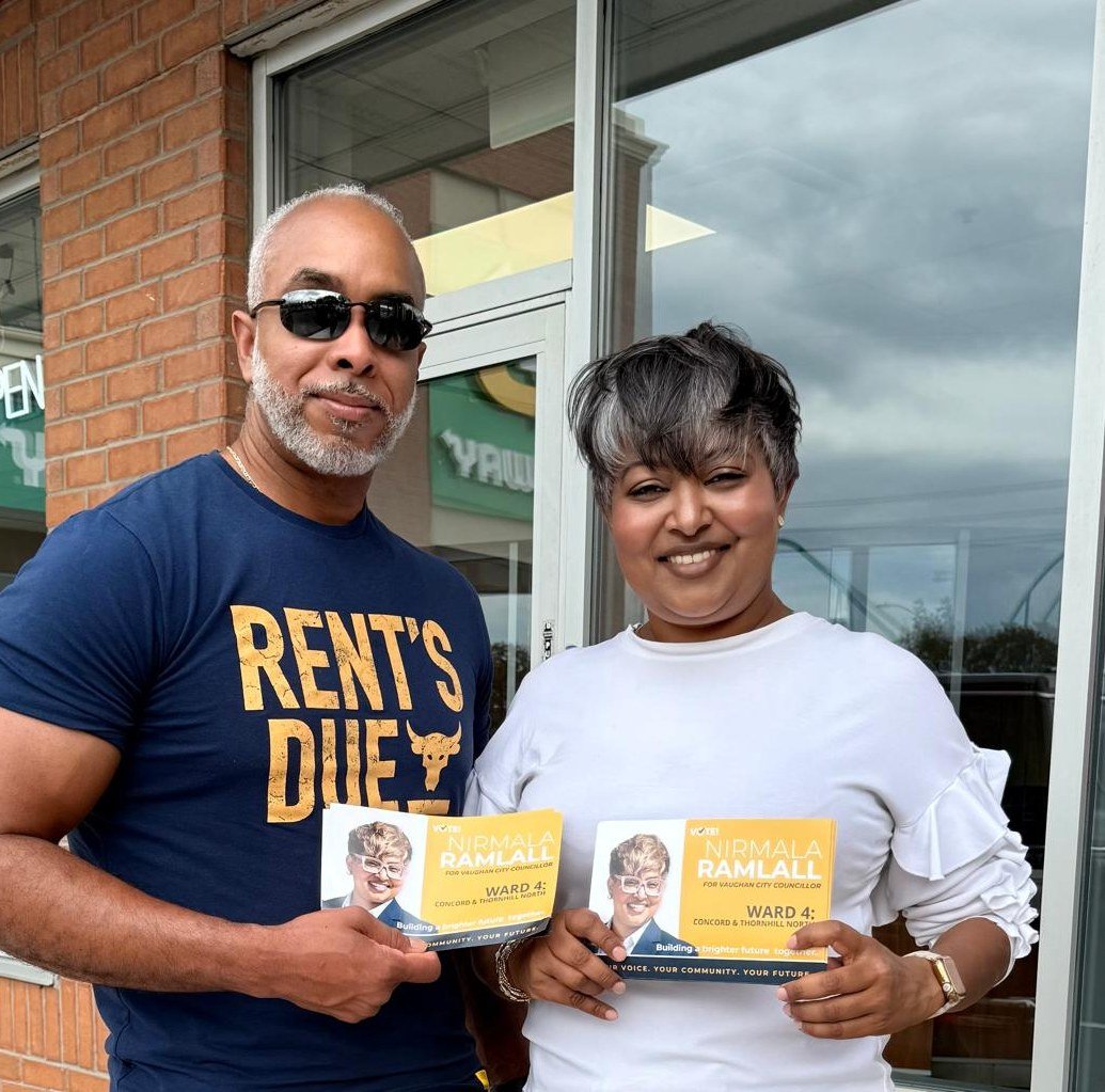 Nirmala Ramlall campaigning with a Ward 4 resident, both holding campaign flyers